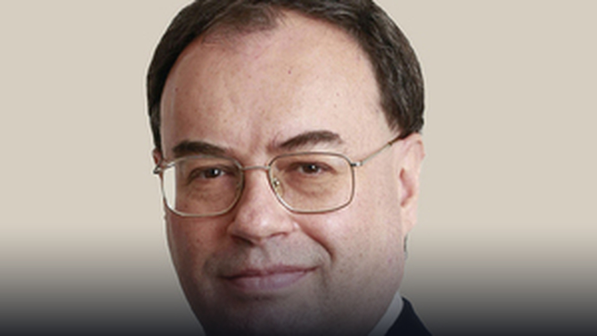 Bank of England Governor Andrew Bailey seated during an official monetary policy briefing.