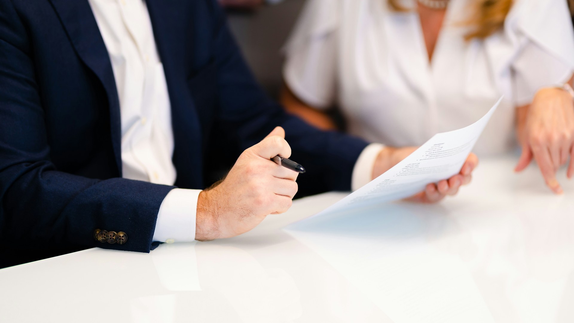 One-on-one consultation between HR and an employee sitting across an office table.
