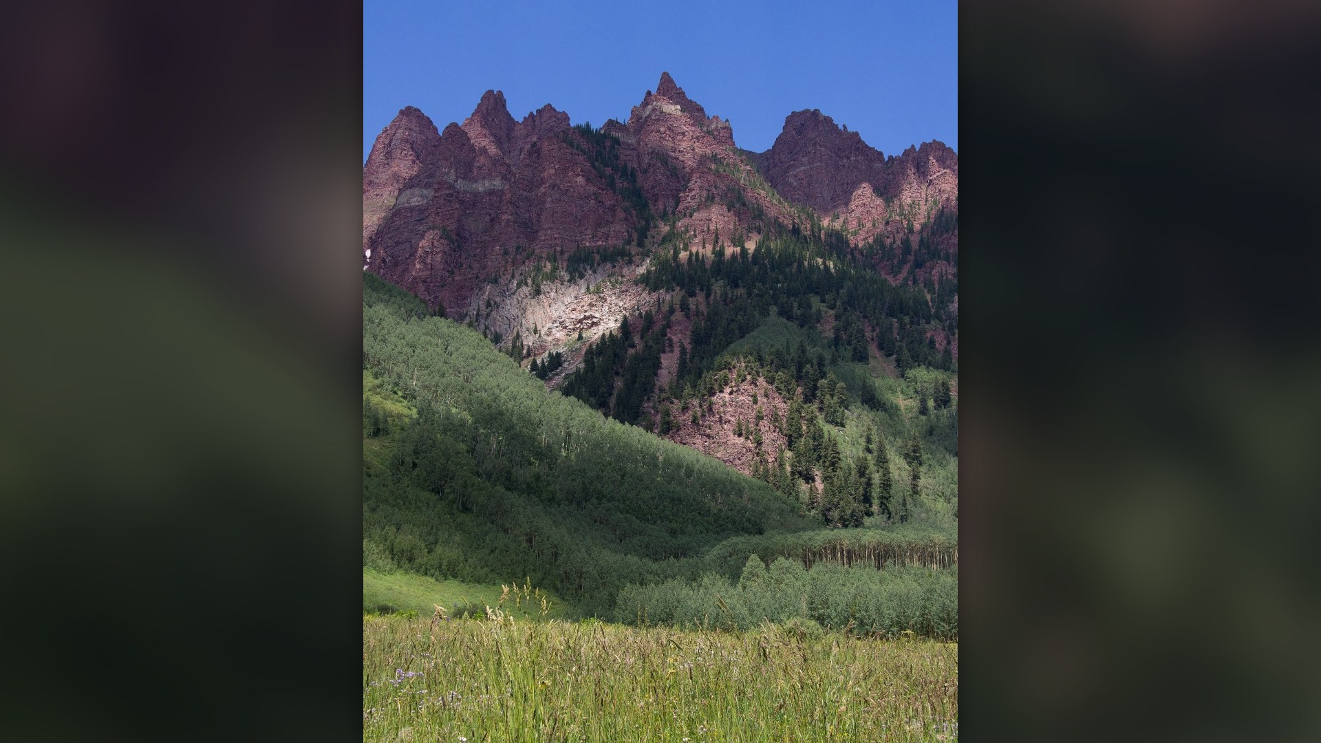 The Maroon Bells mountain peaks reflected in Maroon Lake near Aspen, Colorado.