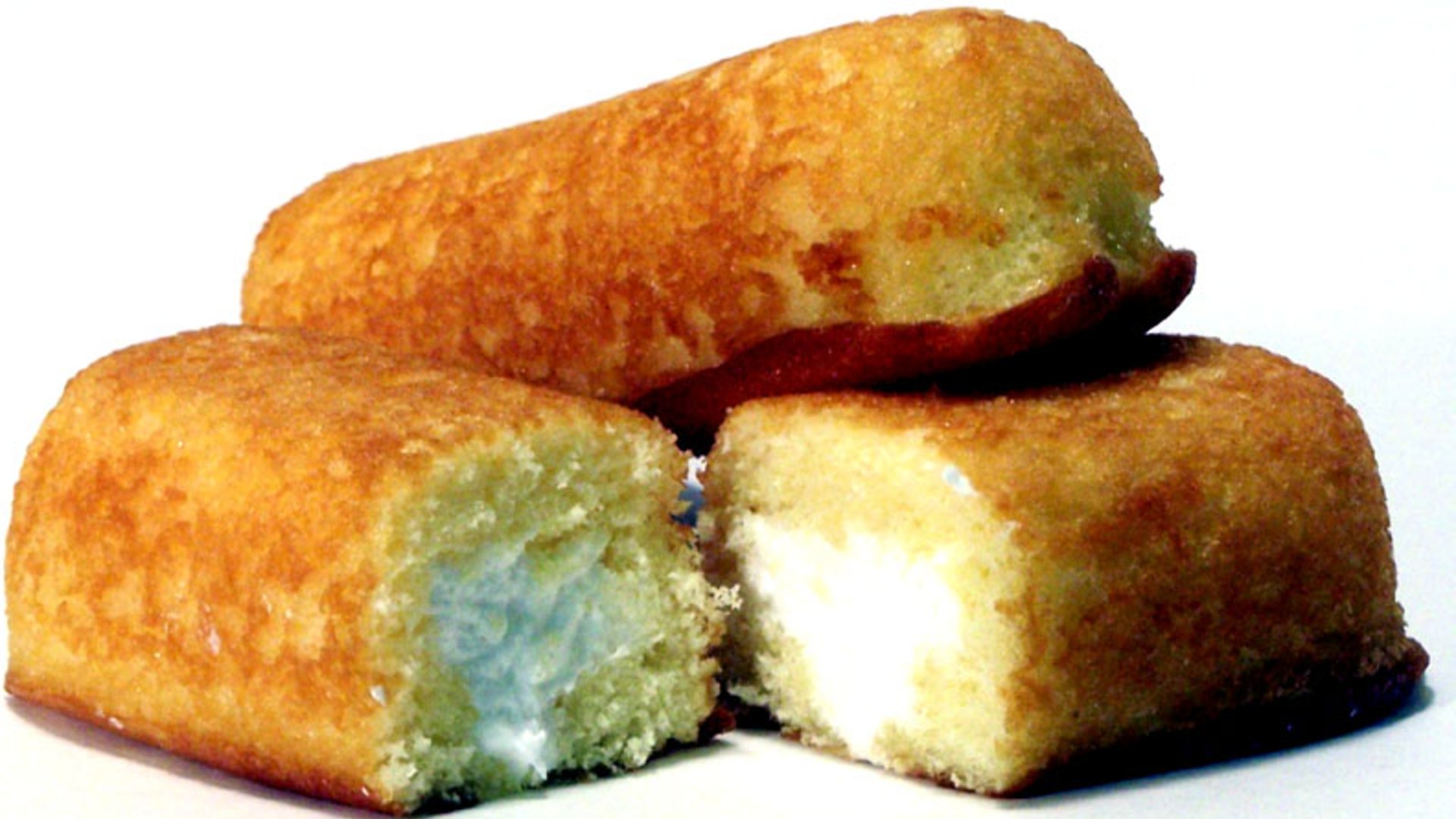 Hostess Twinkies golden sponge cakes split open to show white creme filling.