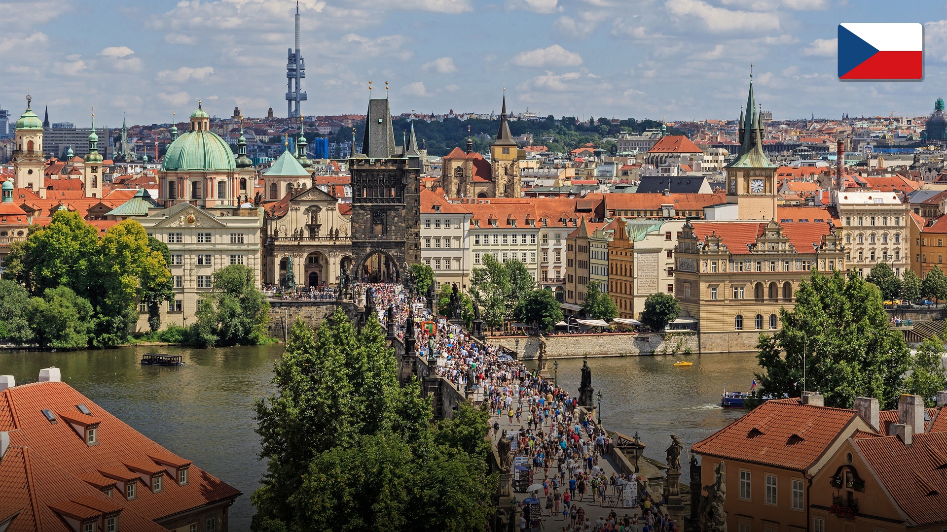 Charles Bridge at sunrise with statues overlooking Prague Castle in the Czech Republic.