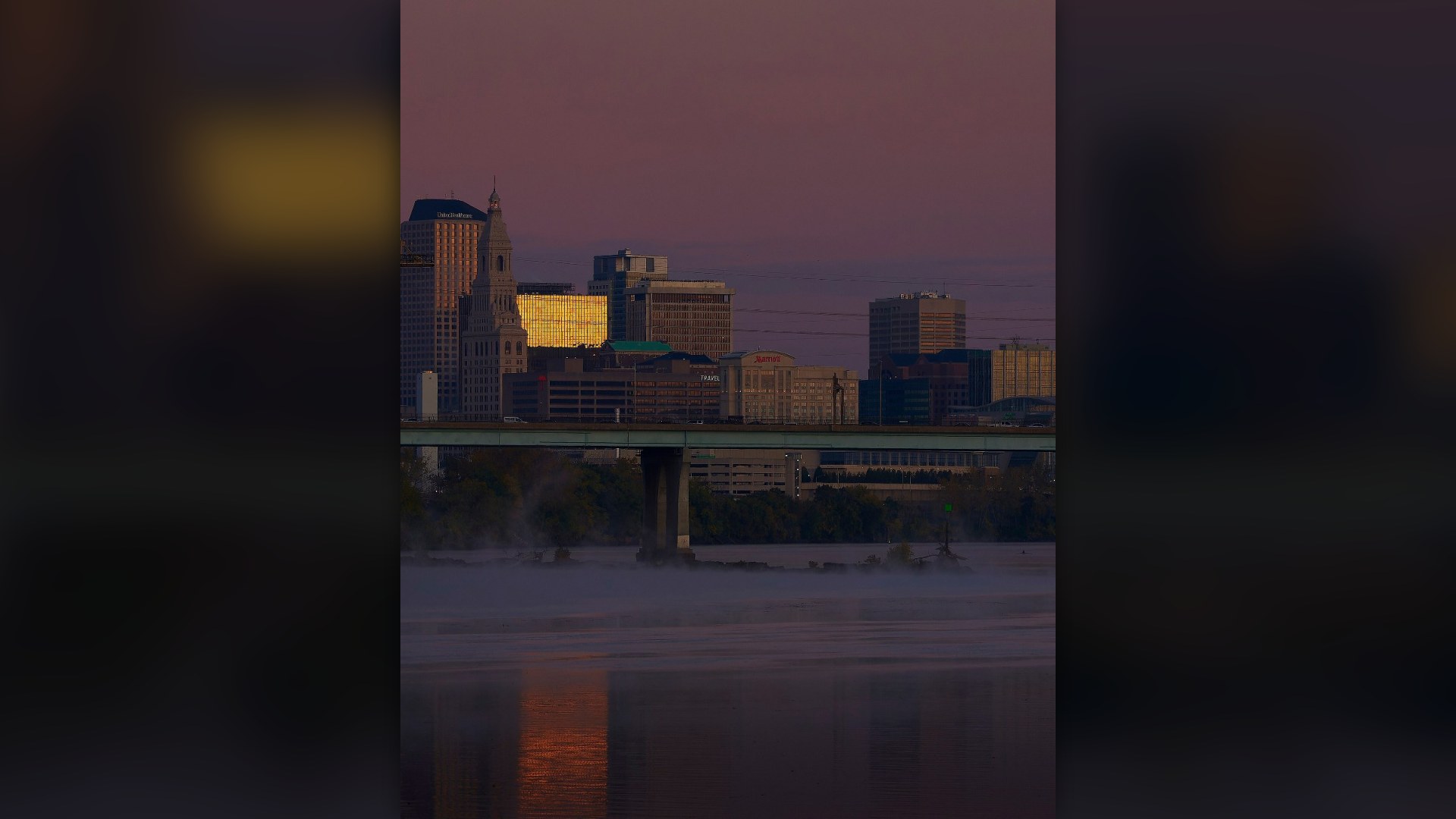 Downtown Hartford skyline reflected in the Connecticut River at sunrise.