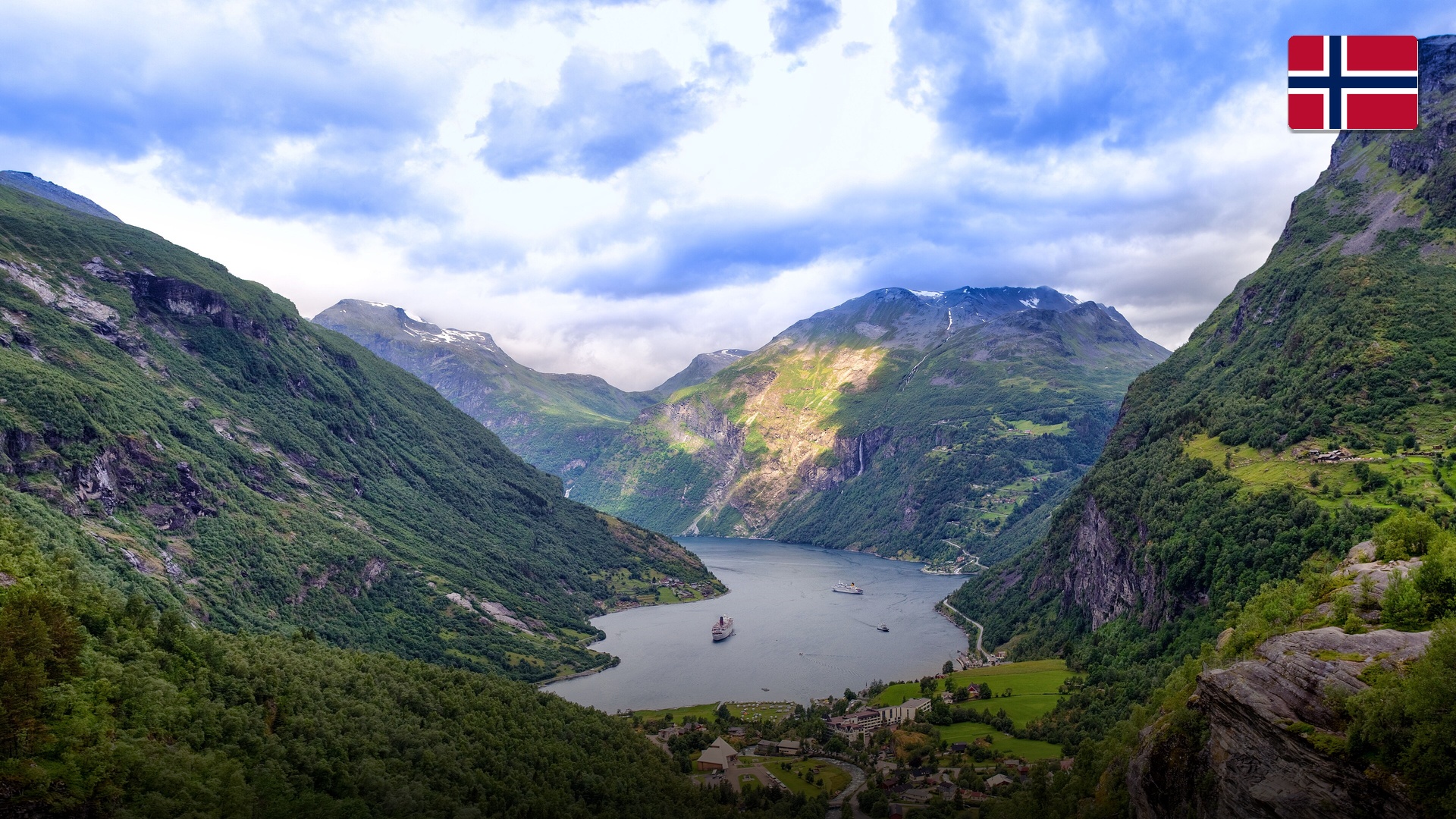 Dramatic steep cliffs and cascading waterfalls tumbling into the deep waters of Geirangerfjord.
