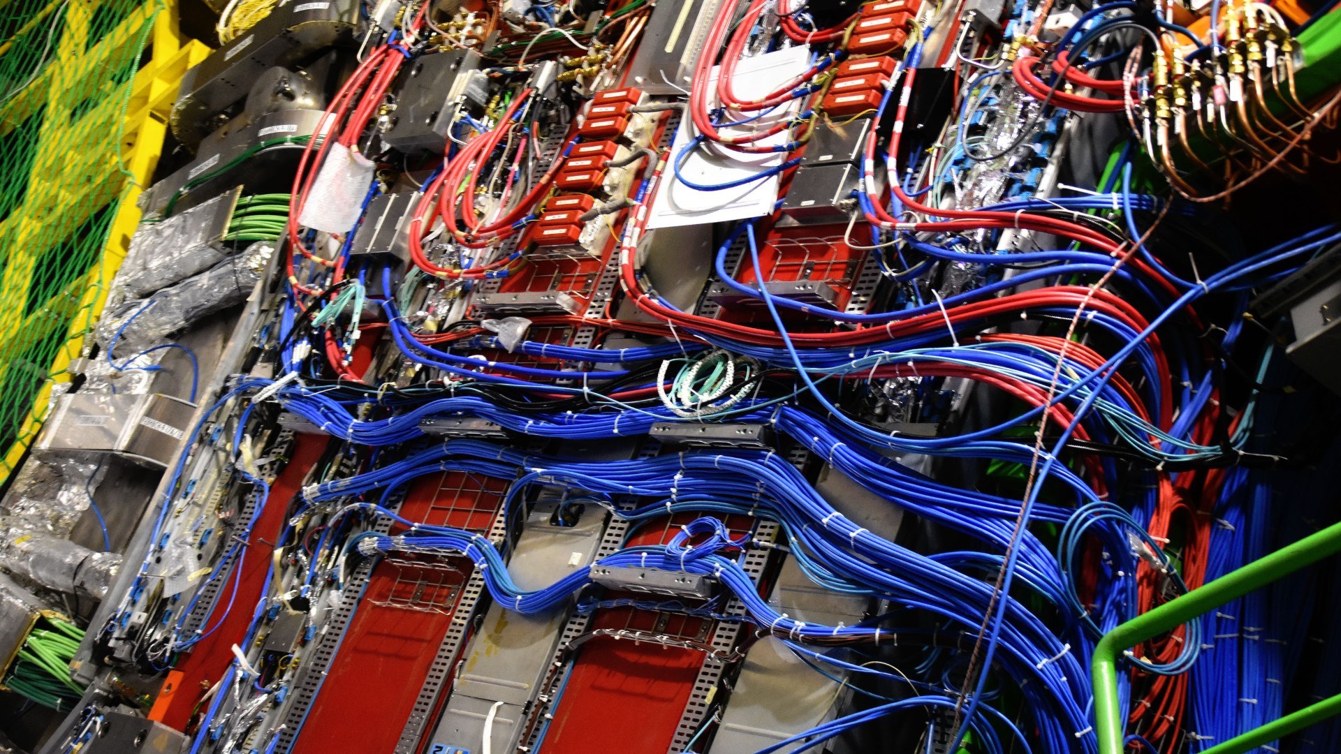 Intricate high-energy particle detector wiring on the CMS experiment at CERN's Large Hadron Collider.