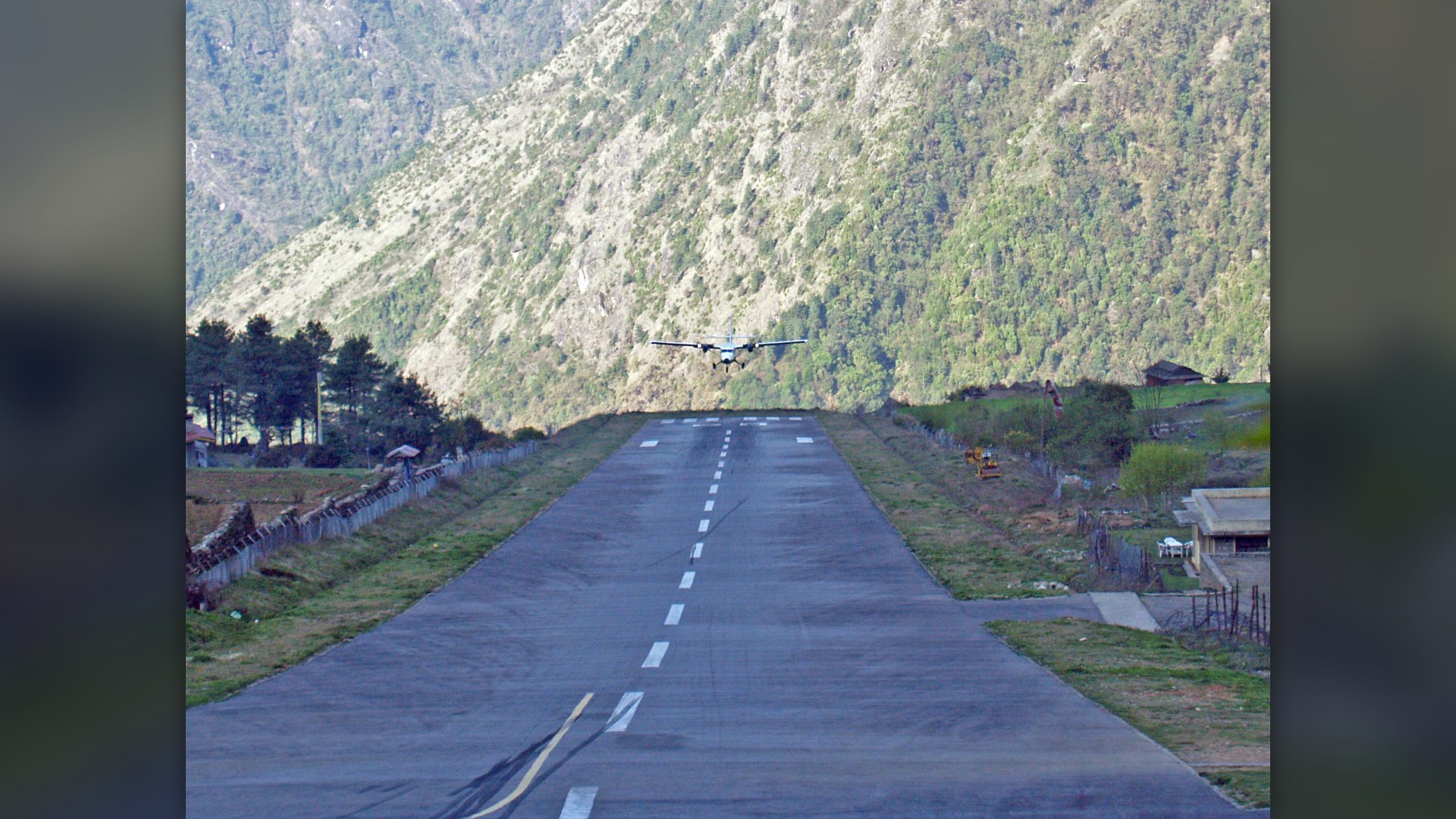 De Havilland Canada DHC-6 Twin Otter landing on the high-altitude sloped runway at Lukla Airport, Nepal.