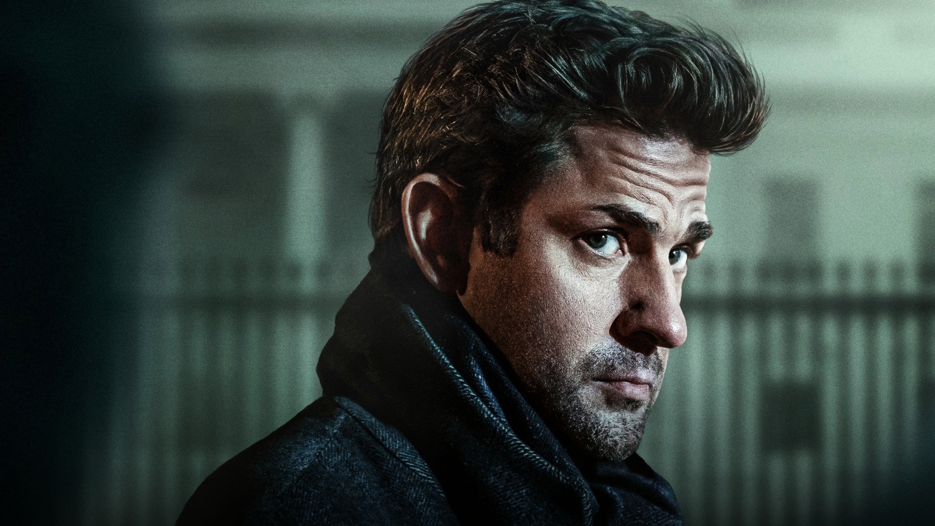 John Krasinski in tactical field combat gear scanning the perimeter during a high-stakes mission.