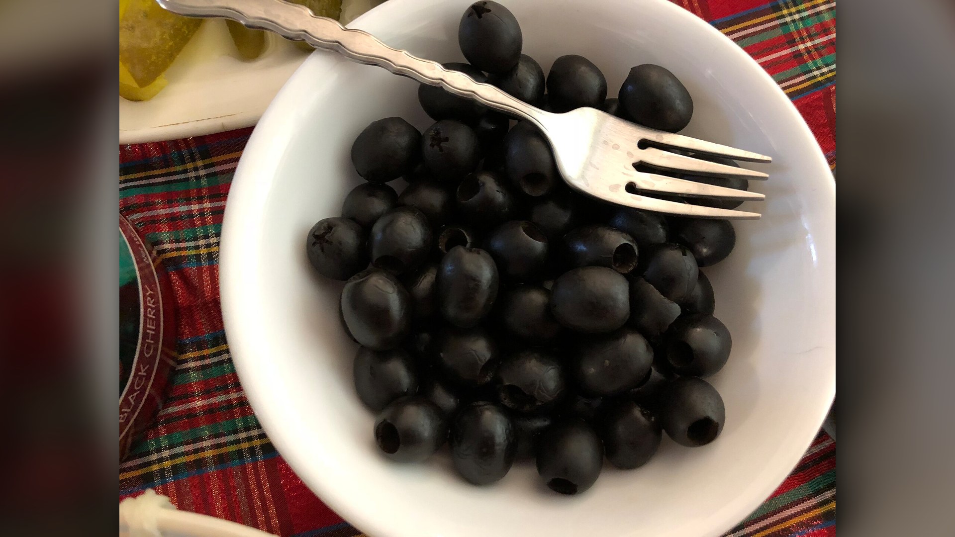 Bowl of cured olives on dinner table