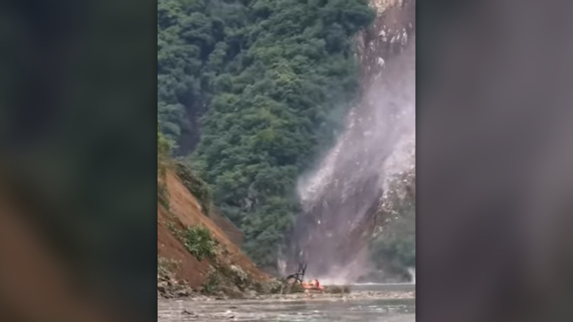 Earthquake-triggered rockslide crashing down a steep mountain gorge into a river in Sichuan, China.