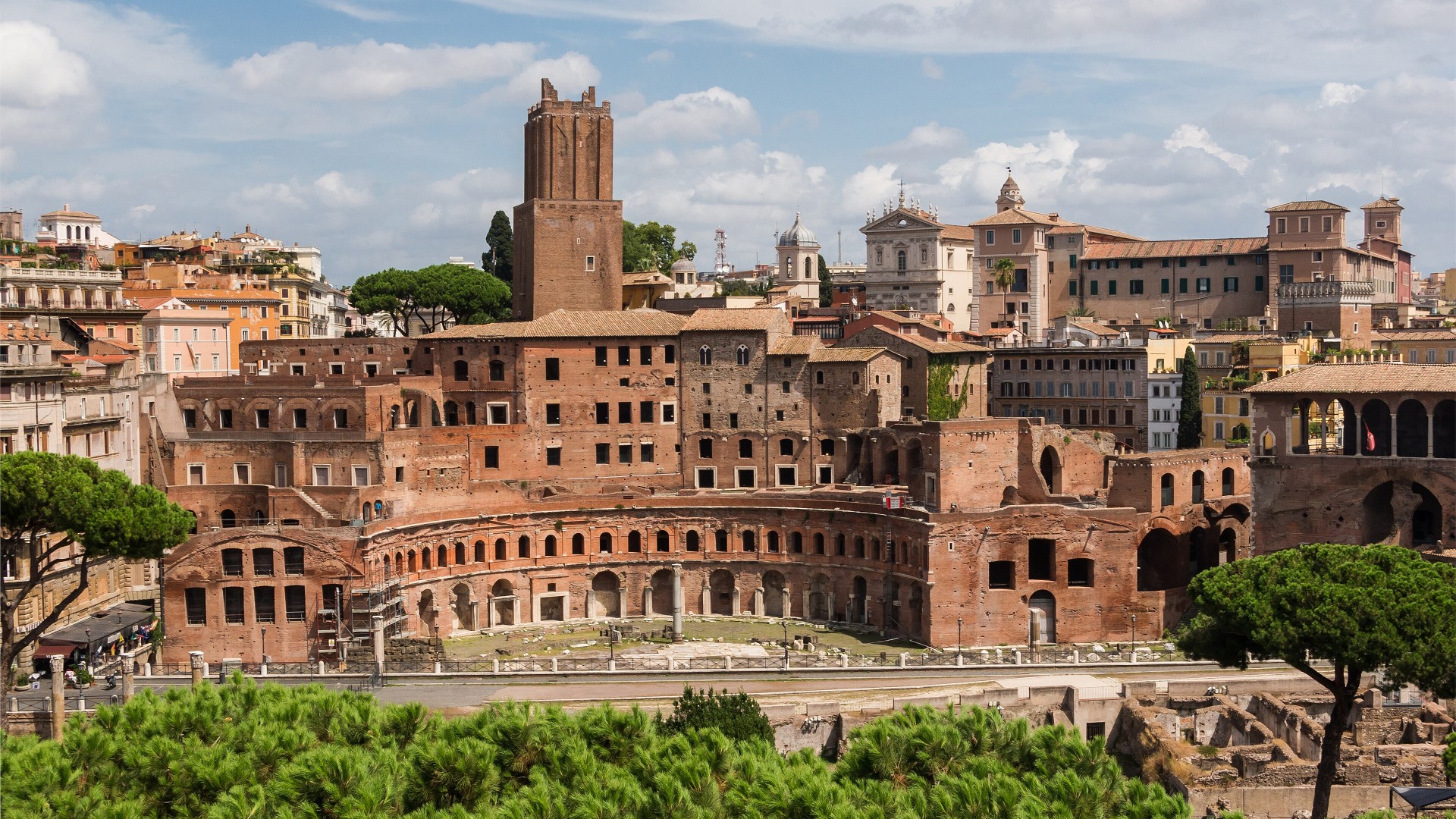 Semicircular brick facade and multi-tiered arches of Trajan's Market in Rome.