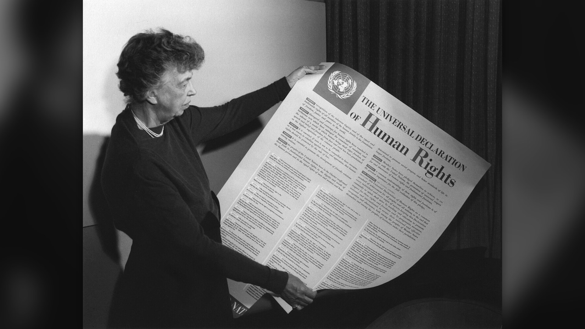 Eleanor Roosevelt holding the iconic Universal Declaration of Human Rights poster in 1948.