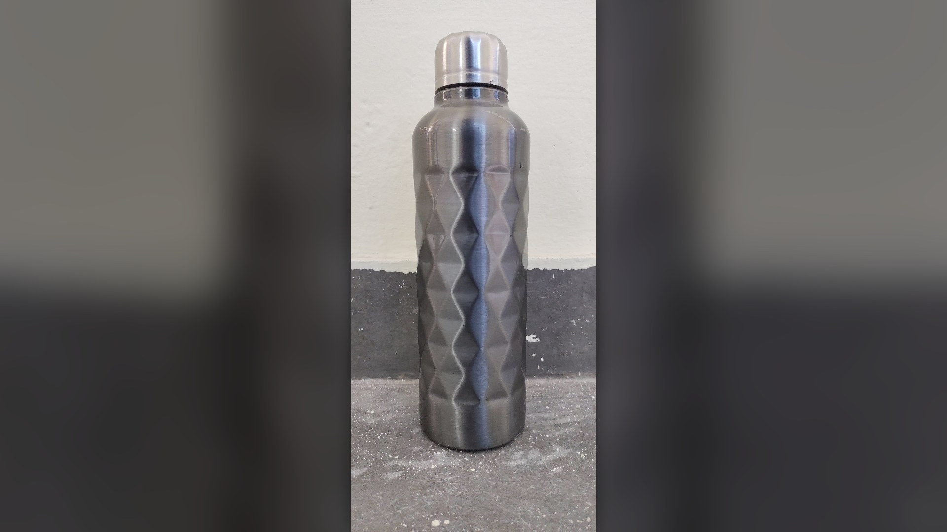 Reusable double-wall stainless steel insulated metal water bottle.