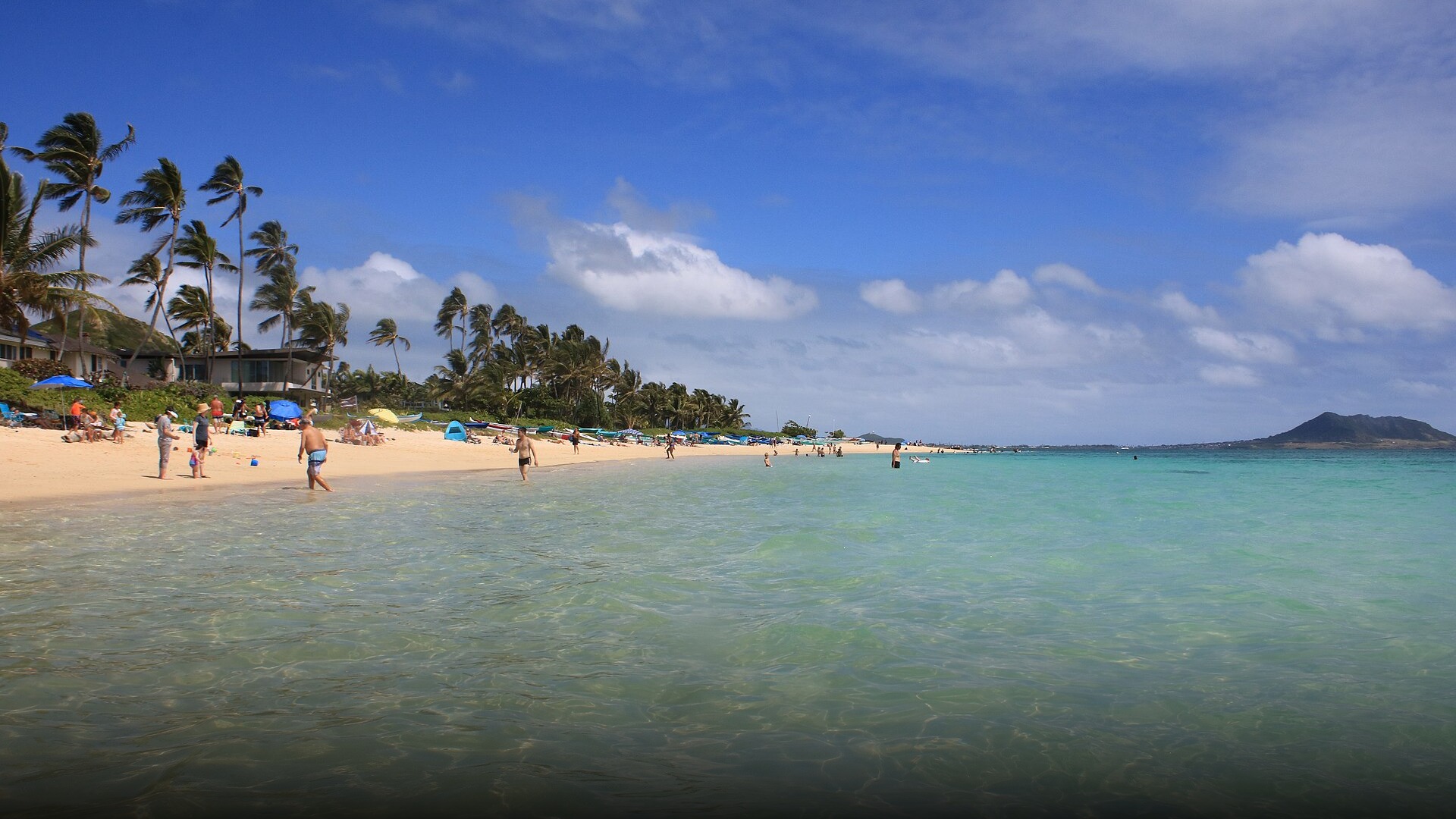 Turquoise ocean water and white sand at Lanikai Beach in Hawaii.