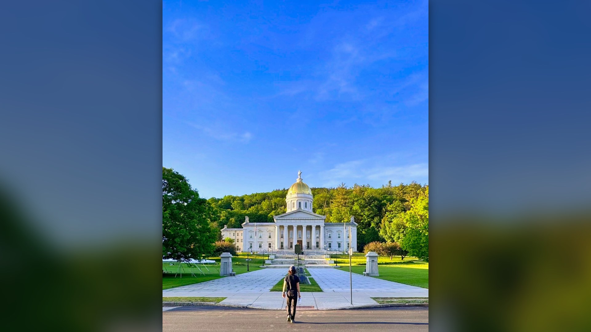Gold-domed Vermont State House backed by forested hills in Montpelier, Vermont.