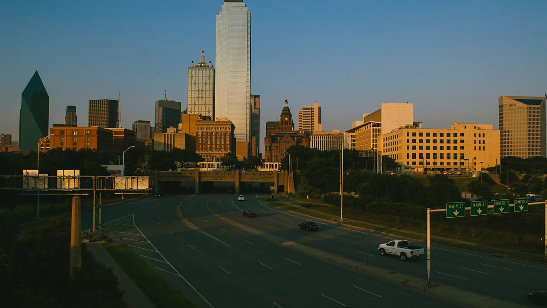 Dallas skyline in the evening with illuminated skyscrapers.