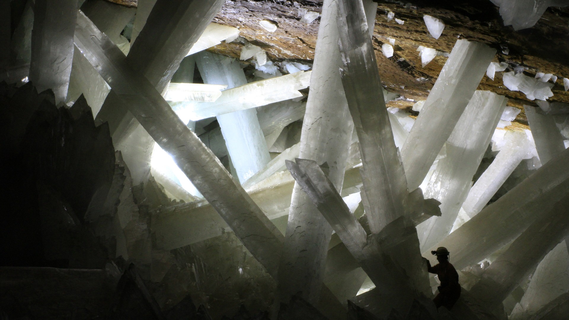 Giant translucent selenite crystal beams crisscrossing the Cave of the Crystals in Naica, Mexico.