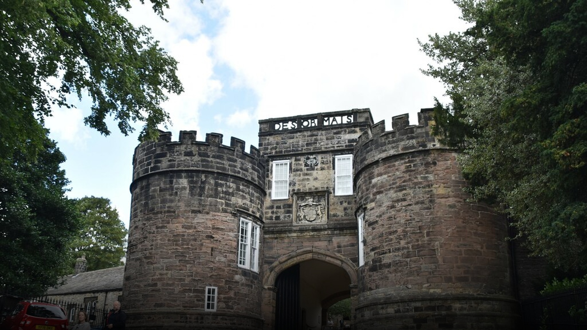 The massive twin round stone towers and gatehouse of medieval Skipton Castle in Craven, North Yorkshire.