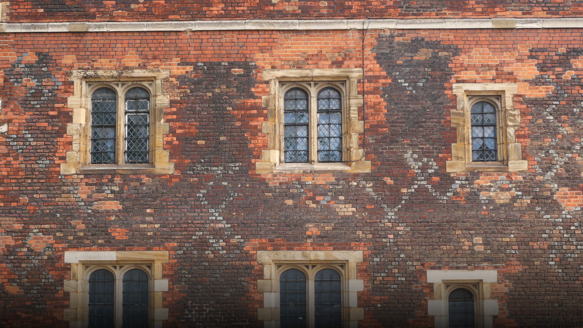 The historic red-brick Tudor gatehouse and towers of Lambeth Palace along the River Thames in London.
