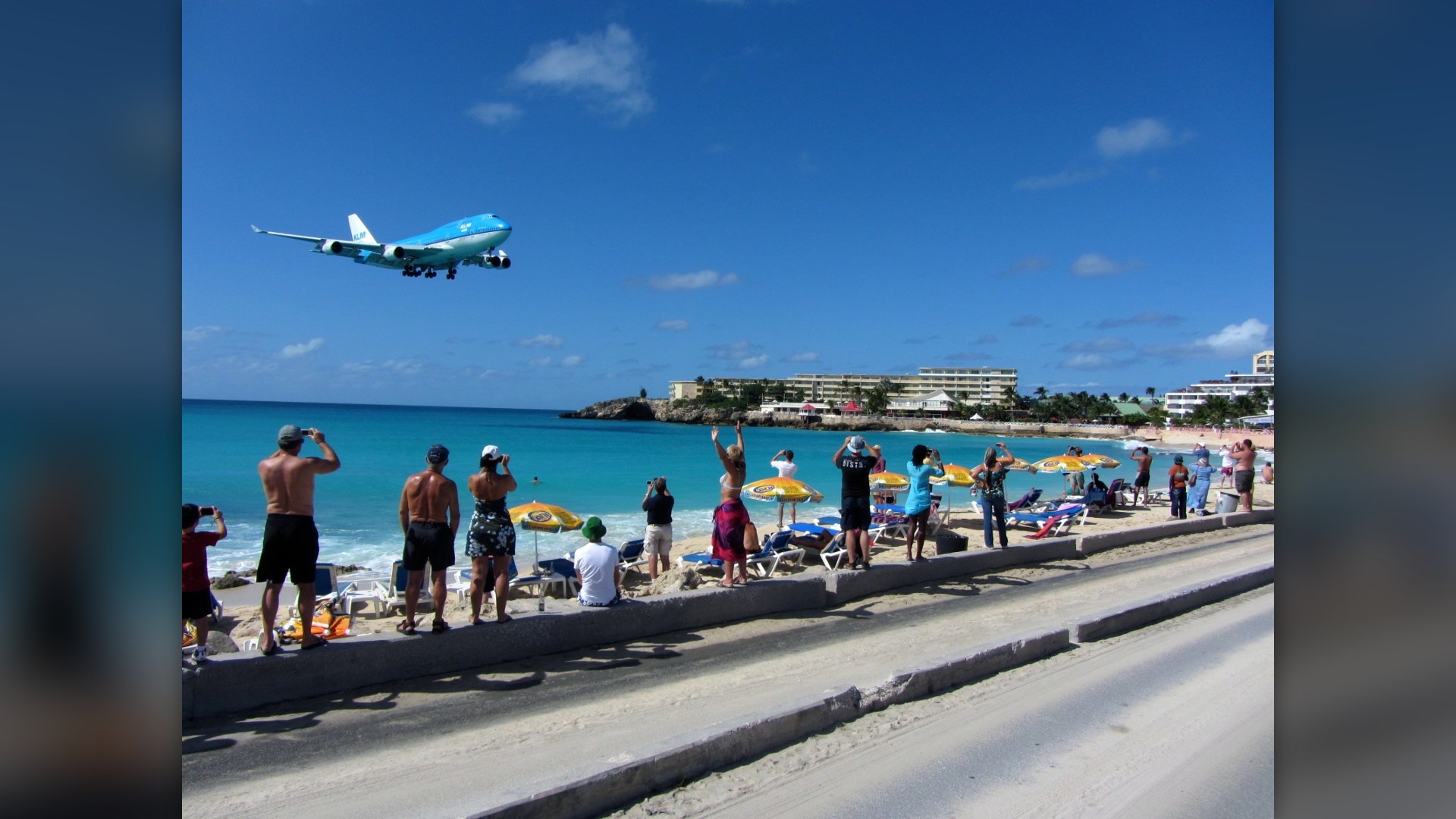 KLM Boeing 747 passing ultra-low over beachgoers on Maho Beach at Princess Juliana International Airport.