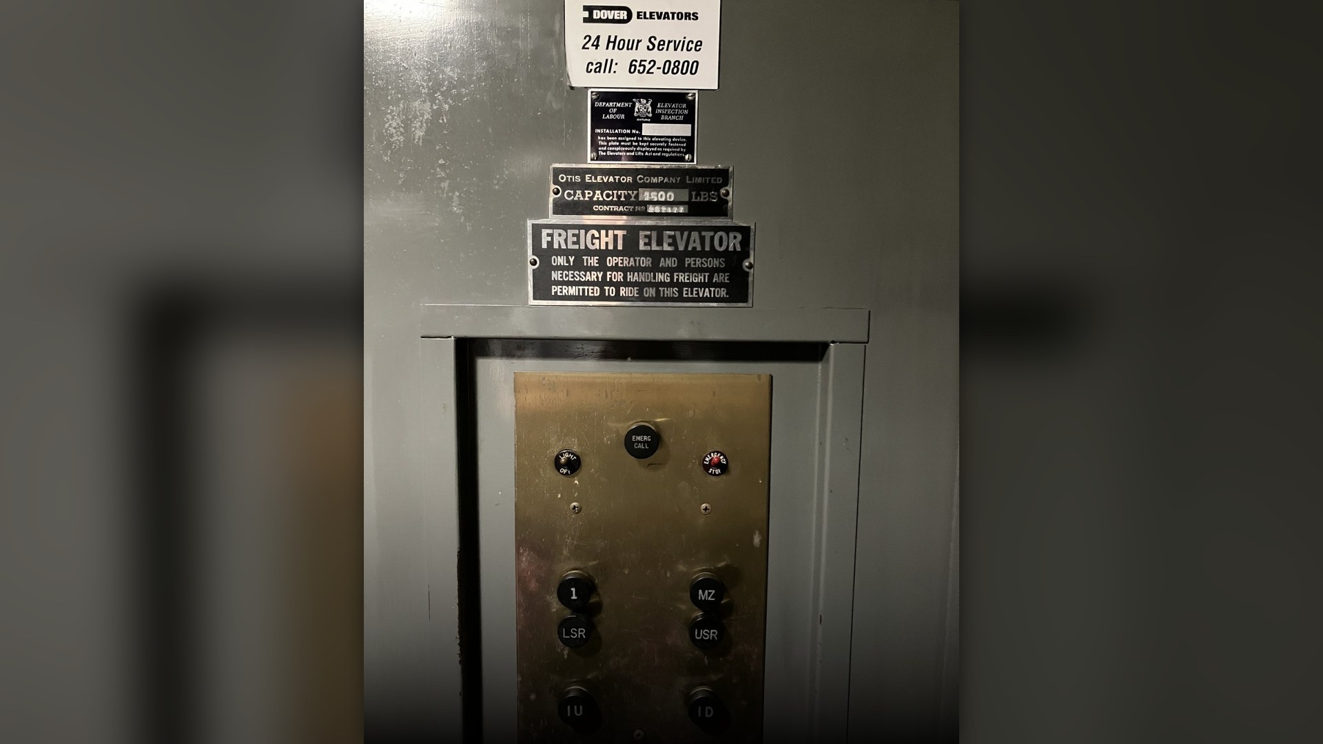 Close-up of stainless steel public elevator floor buttons.