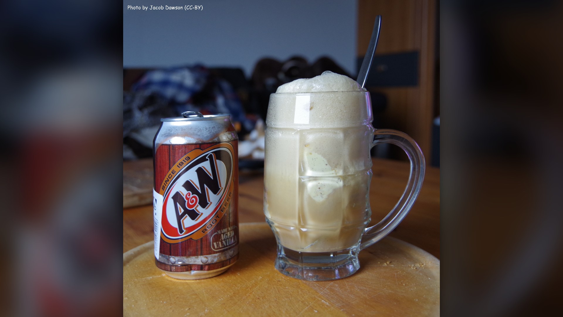 A frosty glass mug of root beer topped with vanilla ice cream.