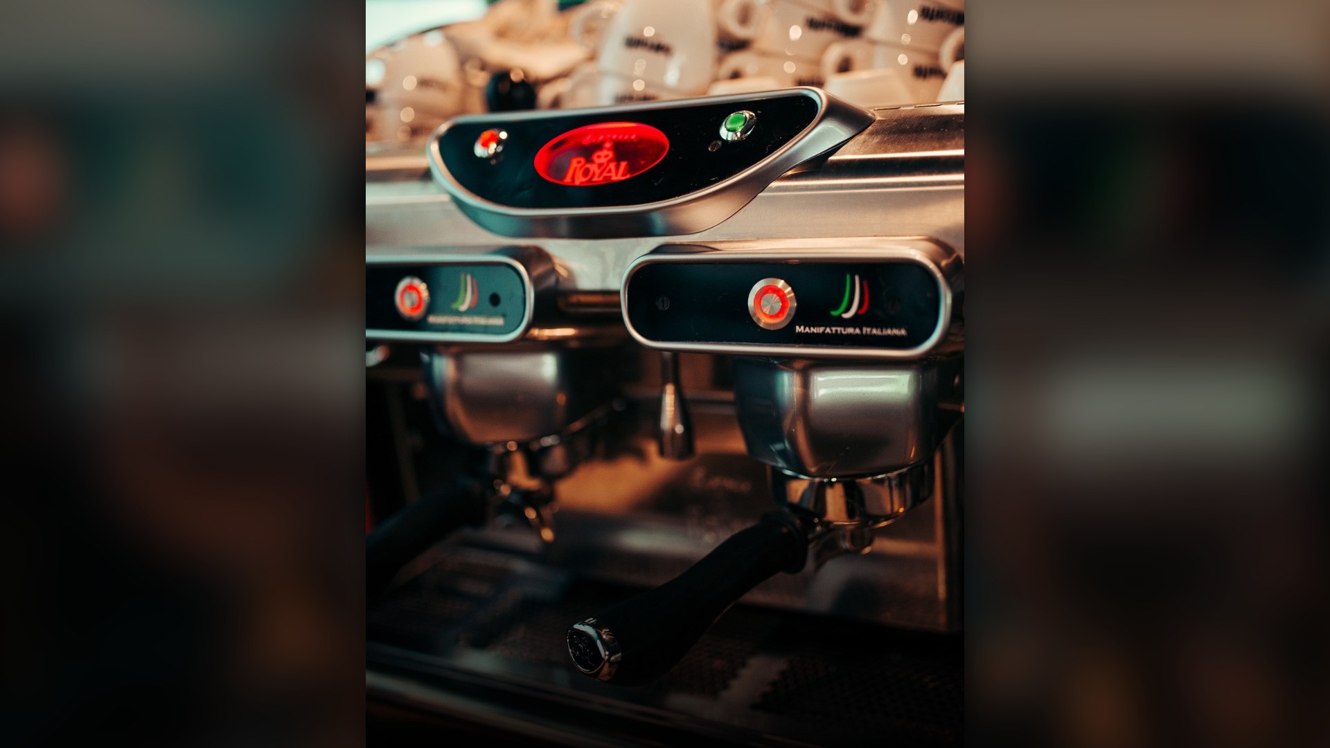 Close-up of a stainless steel coffee maker brewing coffee.