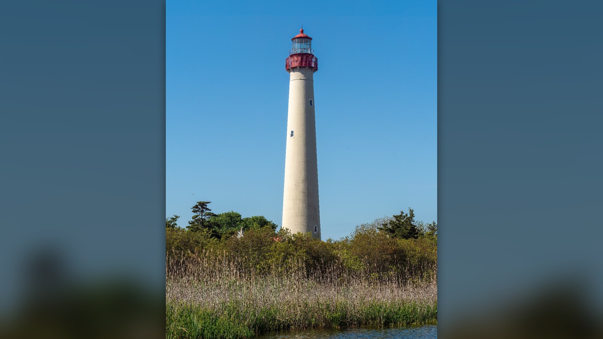 Historic Cape May Lighthouse standing along the Atlantic coastline in Cape May Point, New Jersey.