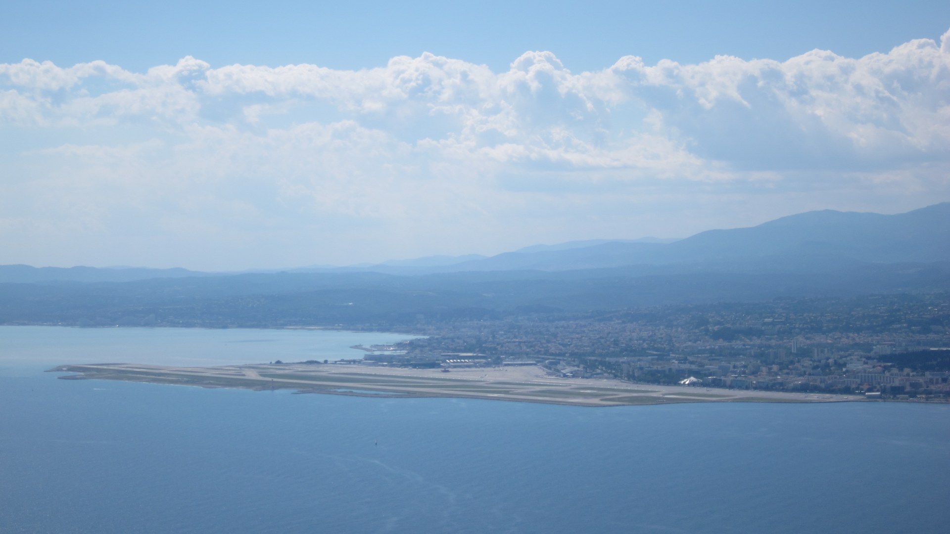 Aerial view turning onto Runway 22R over the Mediterranean Sea at Nice Côte d'Azur Airport.