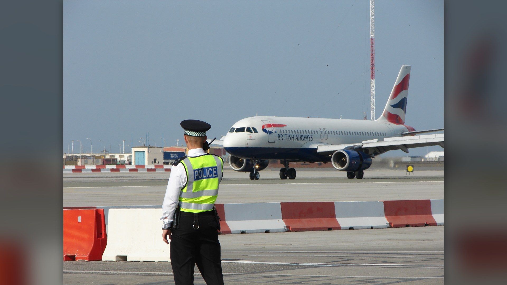 Airbus A320 landing at Gibraltar International Airport beneath the towering Rock of Gibraltar.