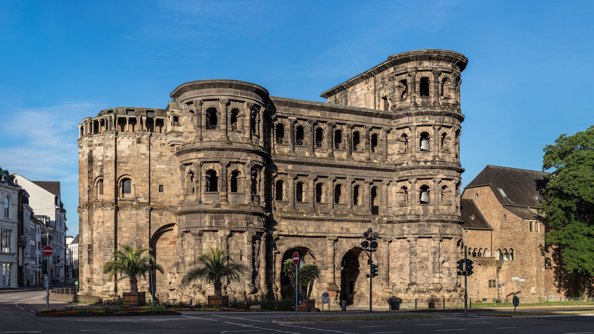 The monumental Roman city gate Porta Nigra illuminated at morning in Trier, Germany.