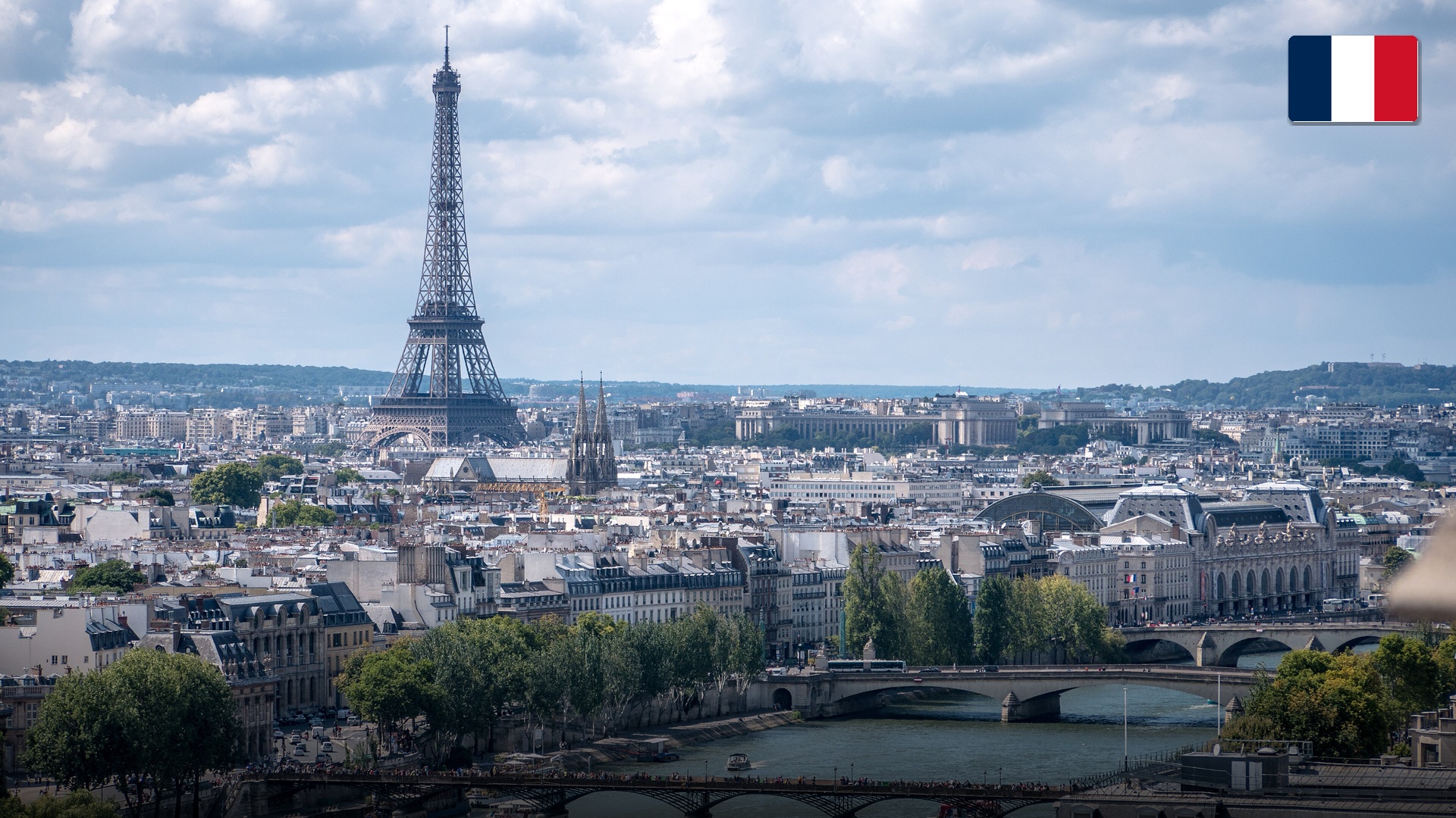 The iconic Eiffel Tower soaring over the Champ de Mars gardens in Paris, France.