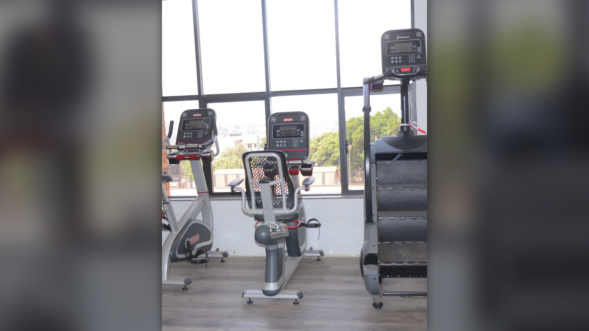 Row of commercial gym resistance exercise machines in a fitness center.