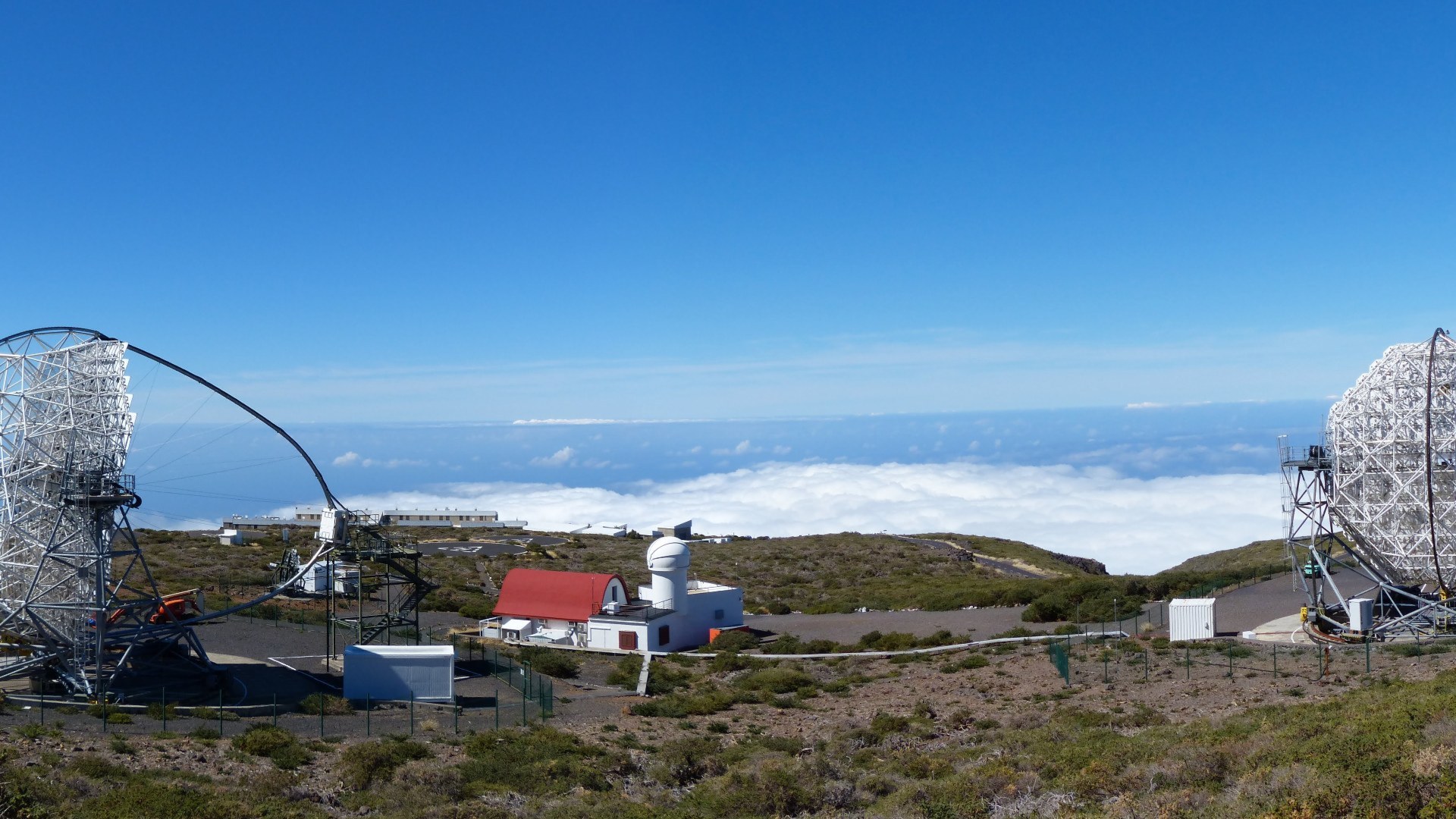 Dual dish reflectors of the MAGIC Cherenkov Telescope observatory above the clouds on La Palma.