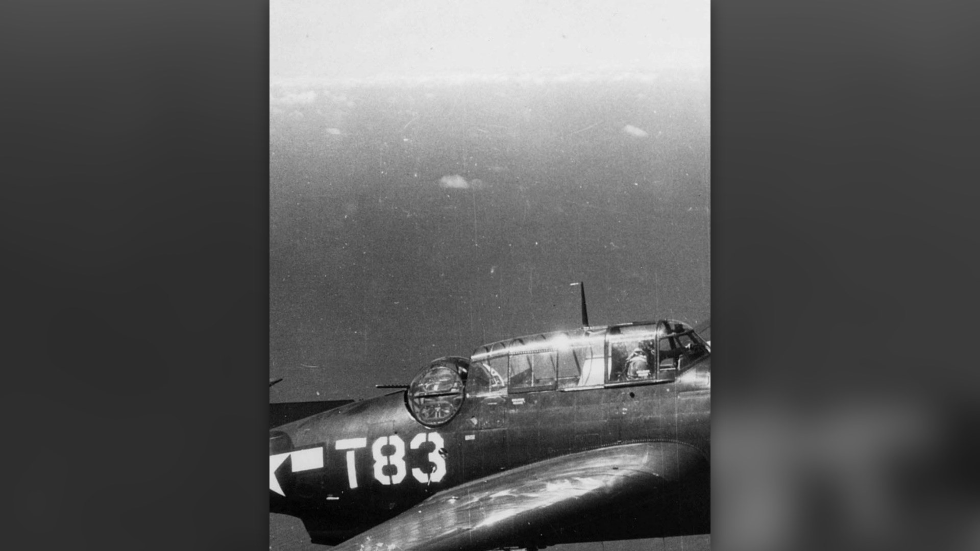 U.S. Navy Grumman TBM Avenger torpedo bomber flying over ocean waters in 1945