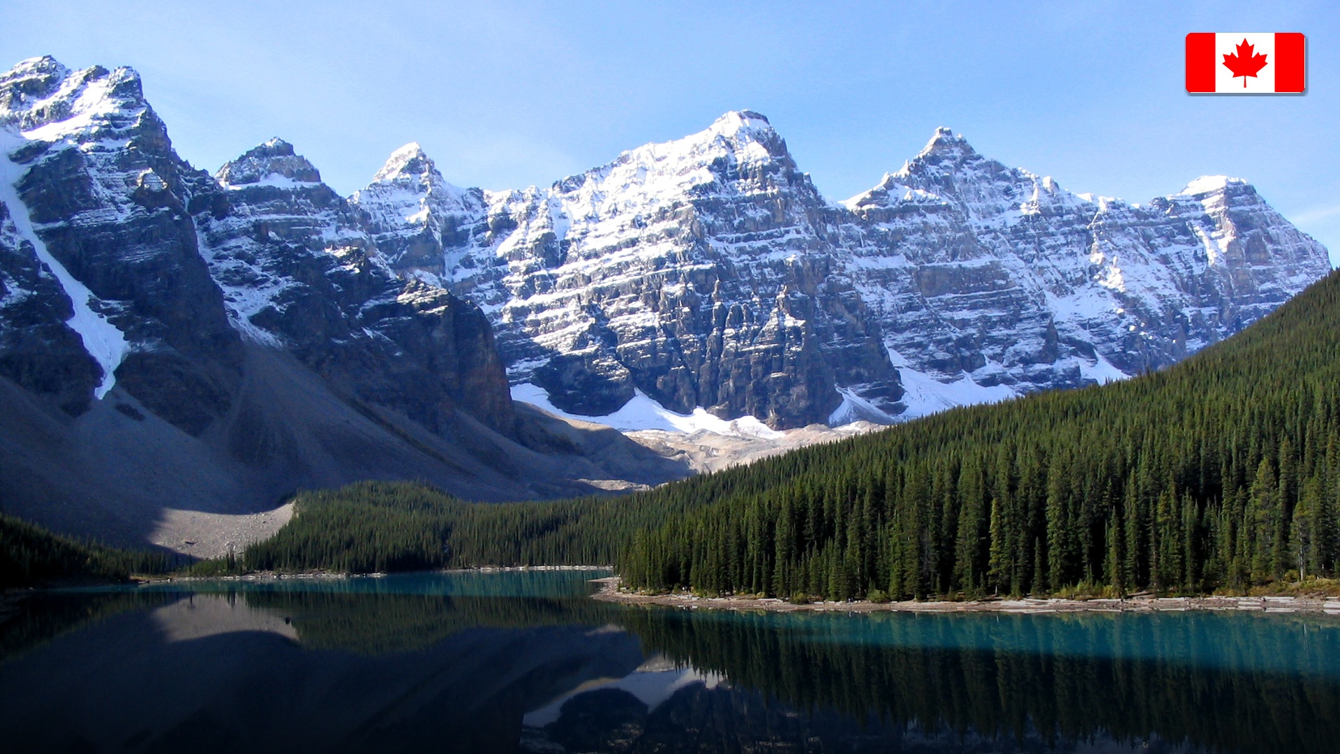 Vibrant turquoise waters of Moraine Lake backed by the Valley of the Ten Peaks in Banff, Canada.