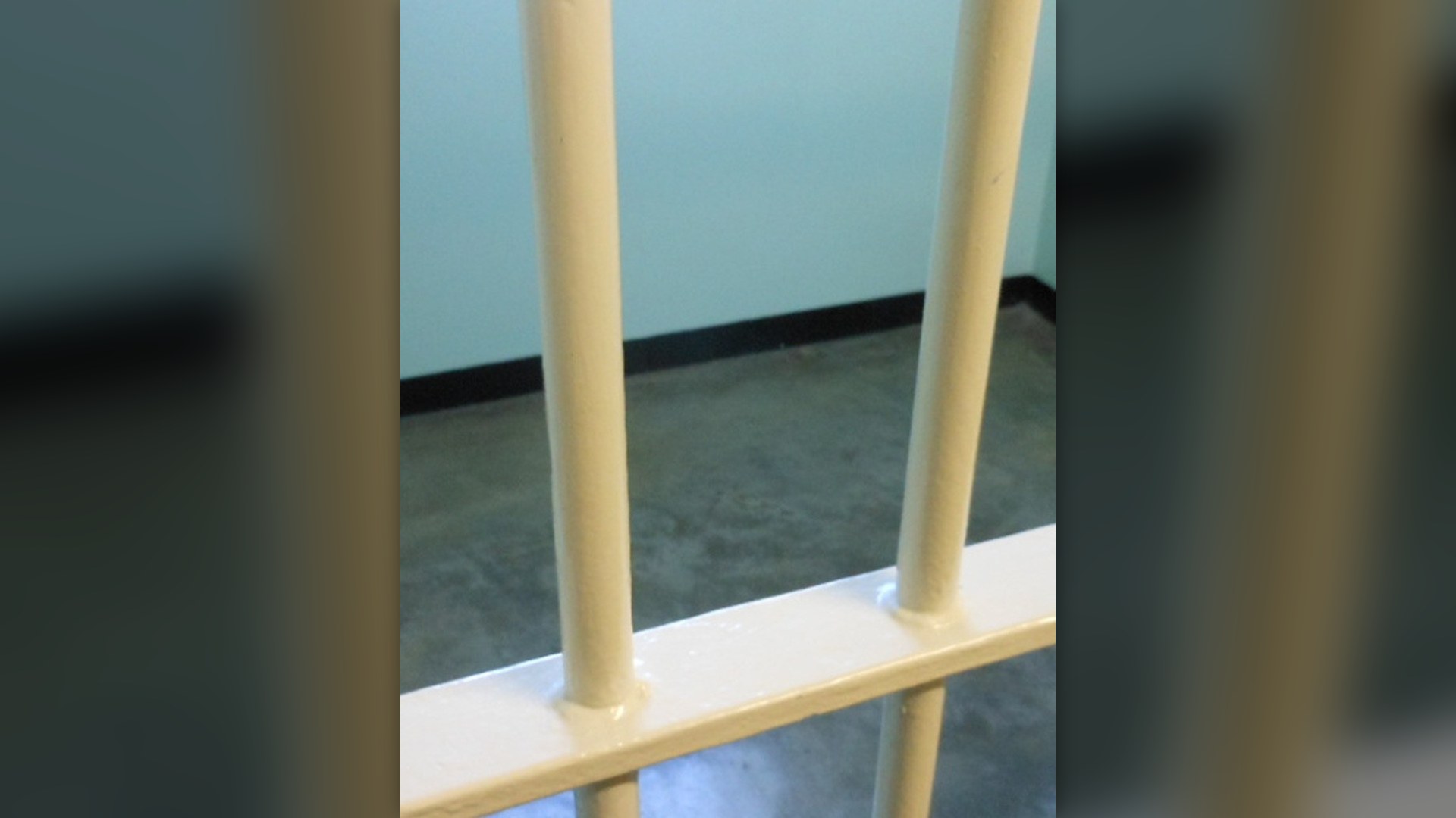 Steel prison cell bars in correctional institution setting
