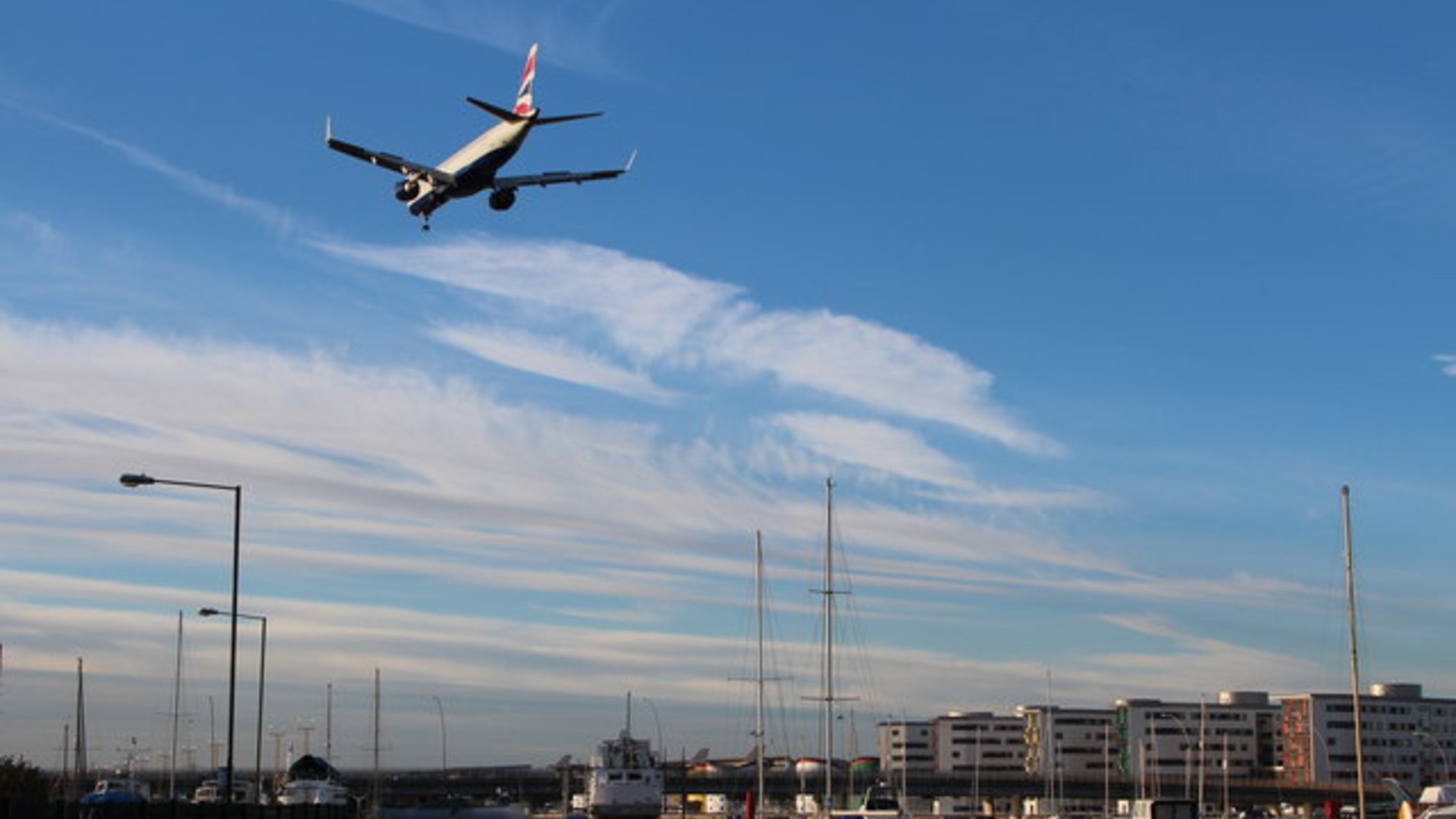 Commercial aircraft descending onto the docklands runway at London City Airport.