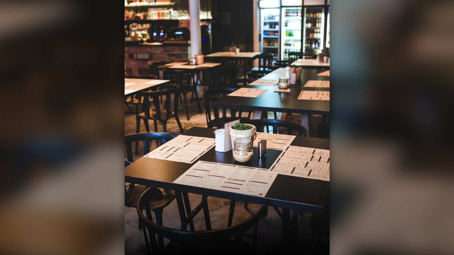 Printed restaurant menu resting on a wooden dining table.