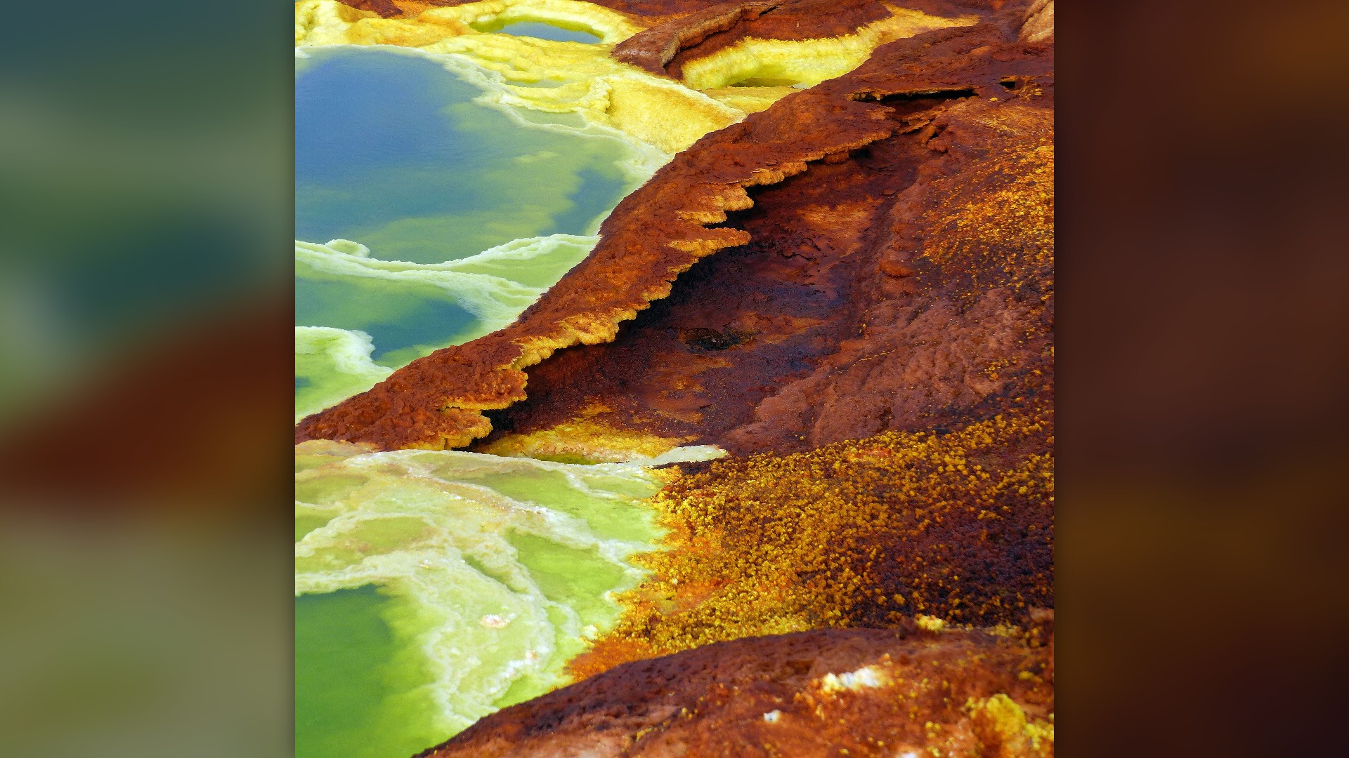 Neon yellow and green acidic sulfur pools in the Dallol hydrothermal field of Ethiopia's Danakil Depression.