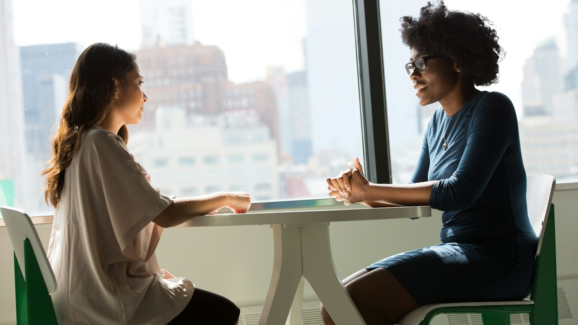 Person pointing a finger across a table during a heated disagreement.