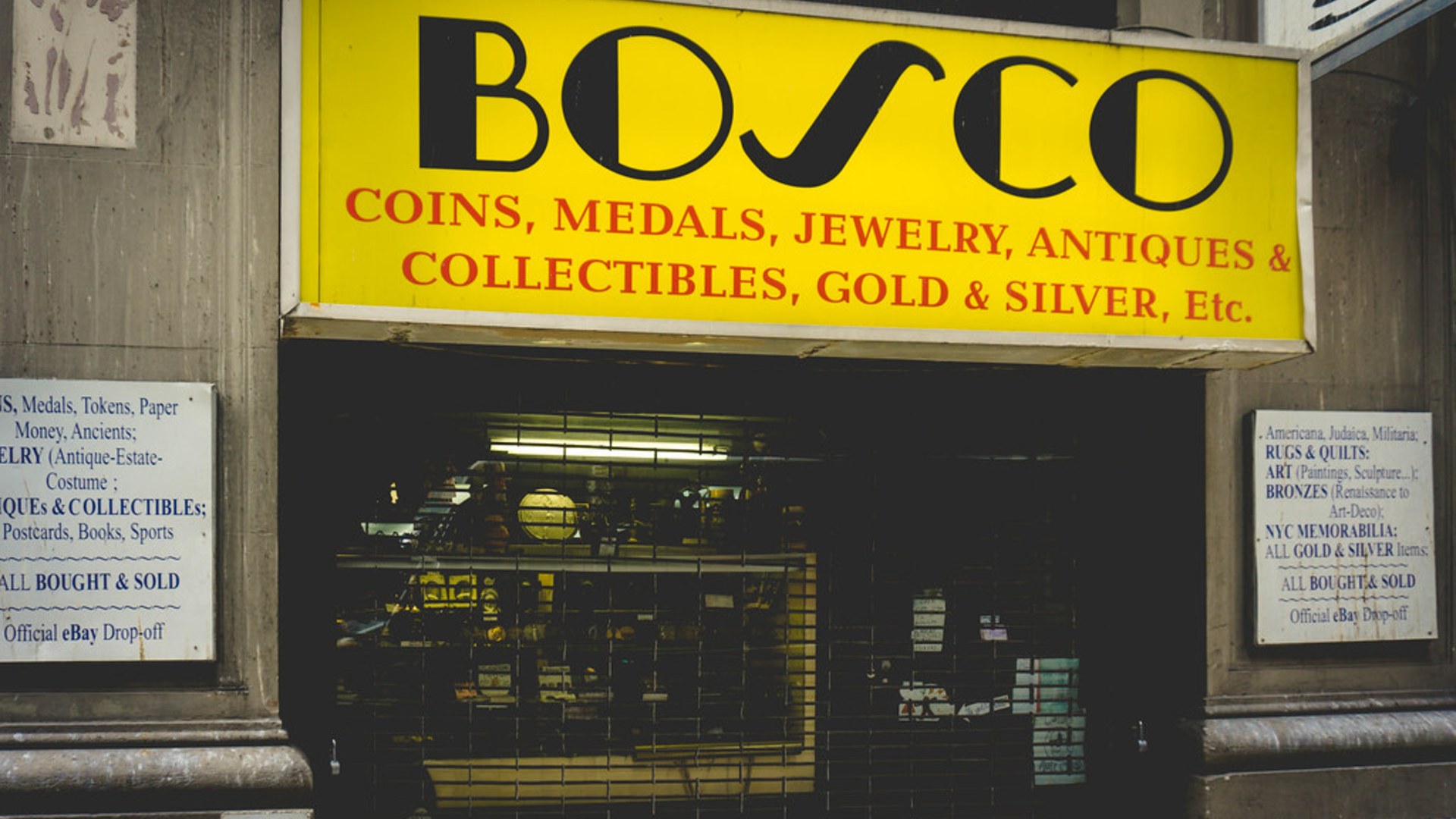 Historic curiosity shop storefront displaying vintage oddities and collector items.