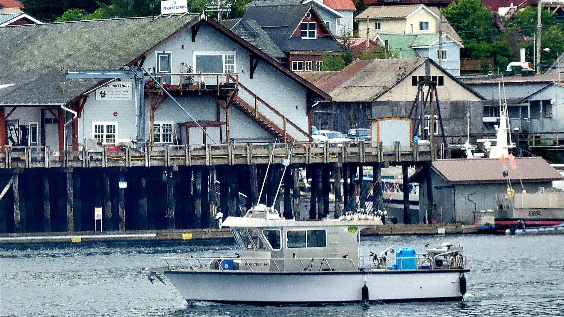 Sitka harbor waterfront with fishing boats and forested mountains in Sitka, Alaska