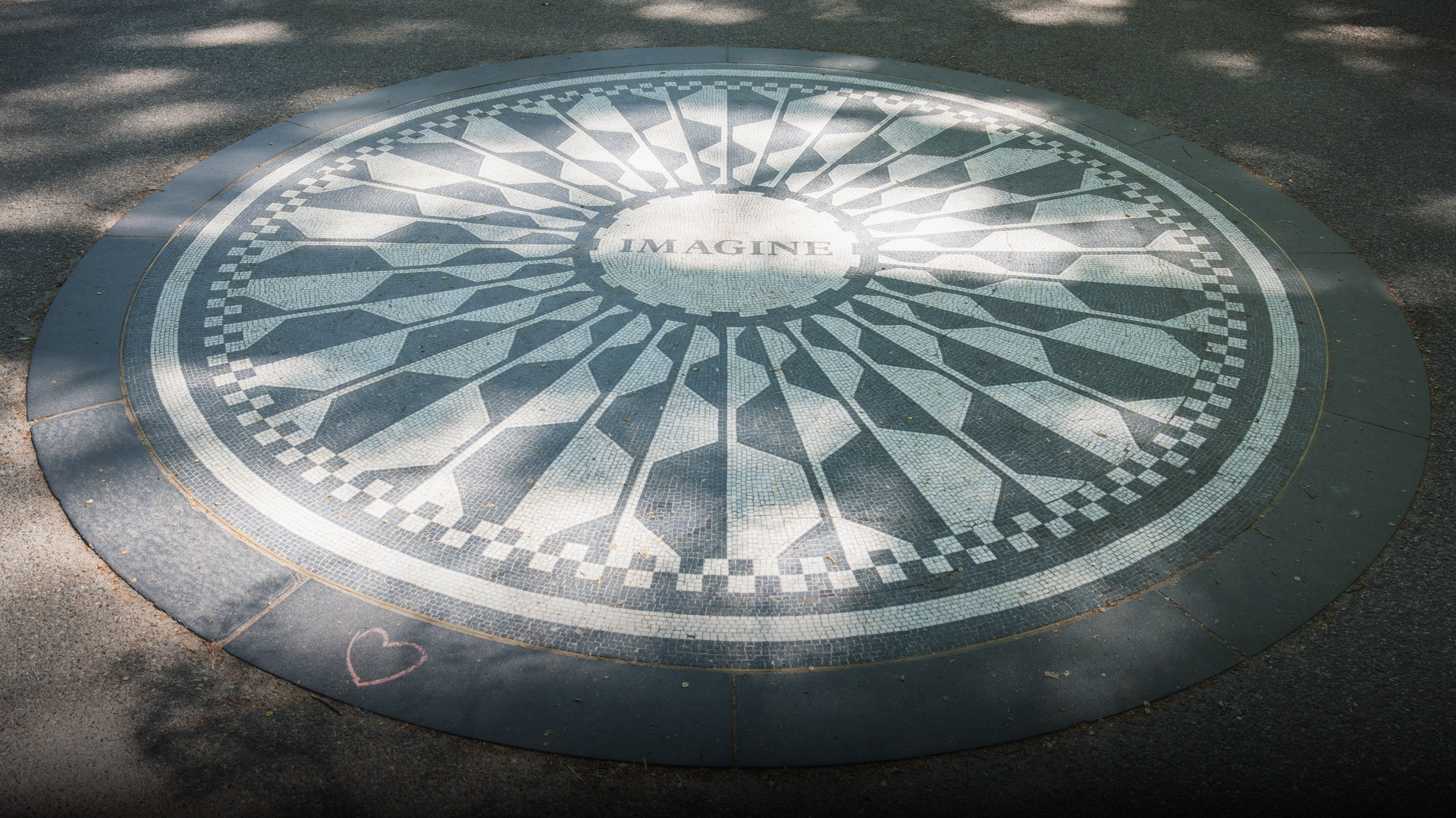 The iconic Imagine circular tile mosaic memorial dedicated to John Lennon in Strawberry Fields, Central Park.