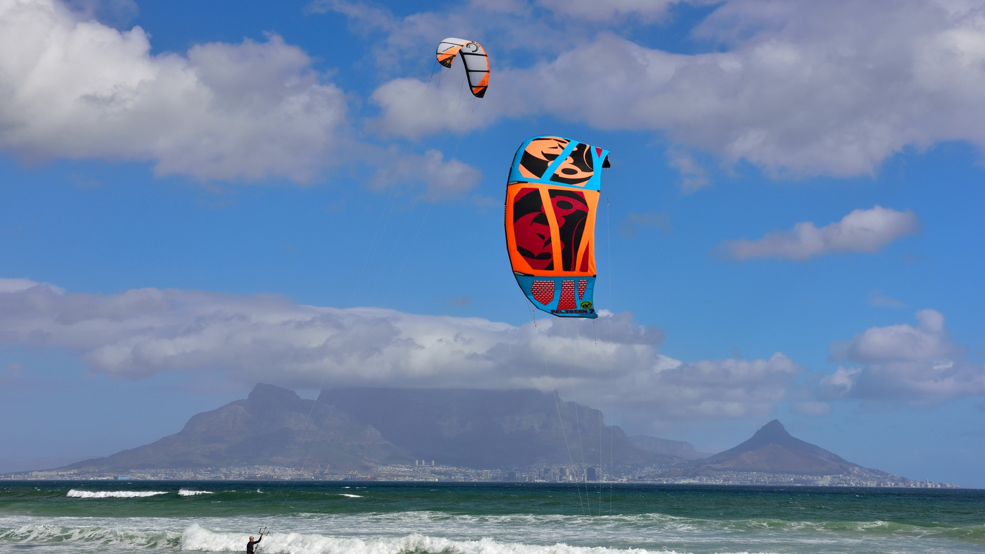 Table Mountain's iconic flat plateau seen across the Atlantic Ocean from the white sands of Bloubergstrand in Cape Town.