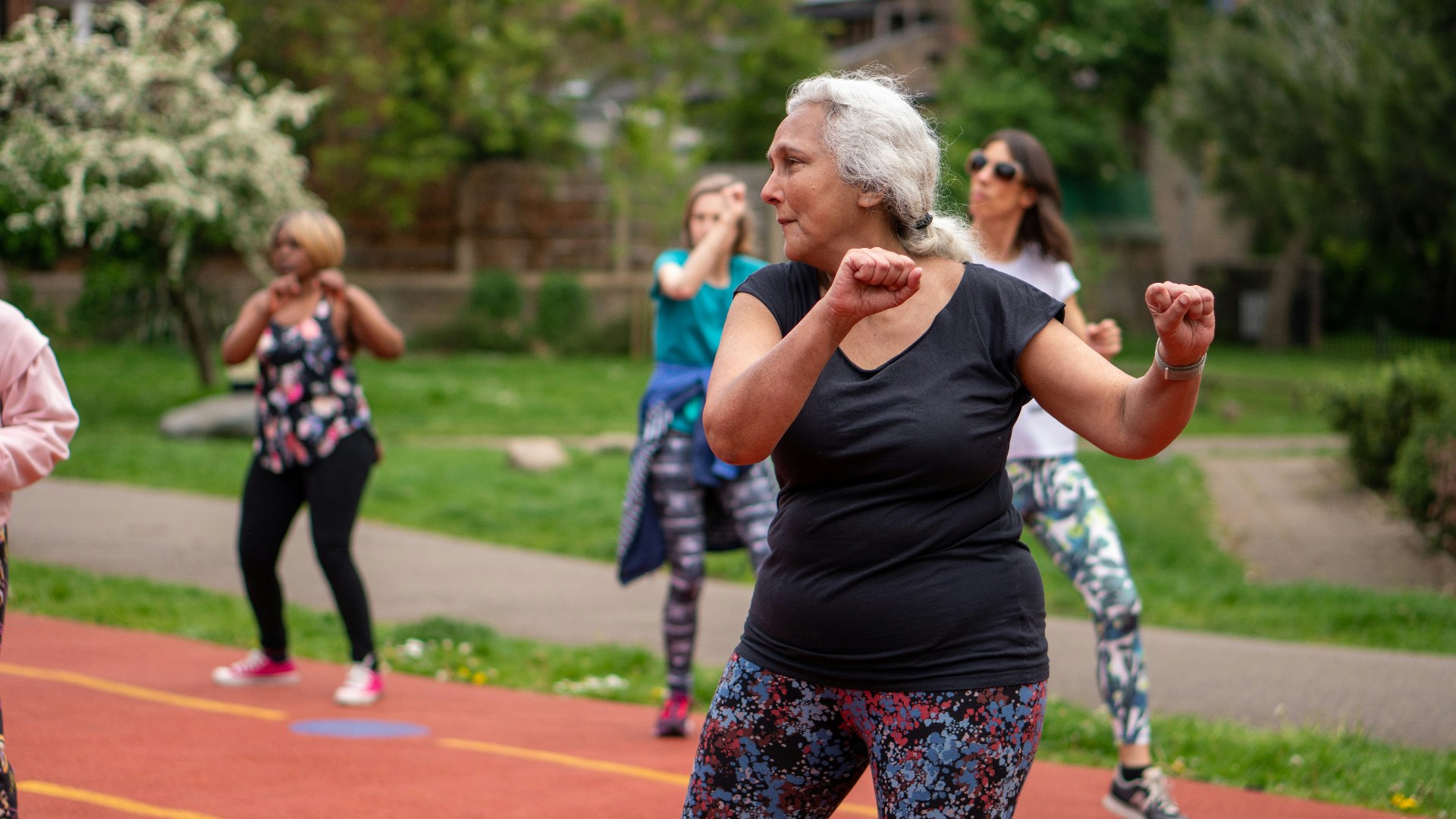 Older adults stretching and staying active on a running track