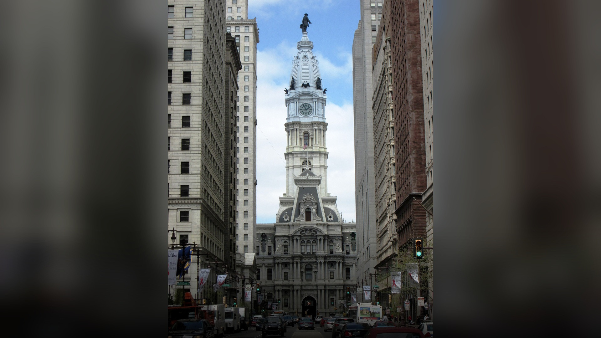 Street-level perspective looking north on Broad Street toward historic Philadelphia City Hall.