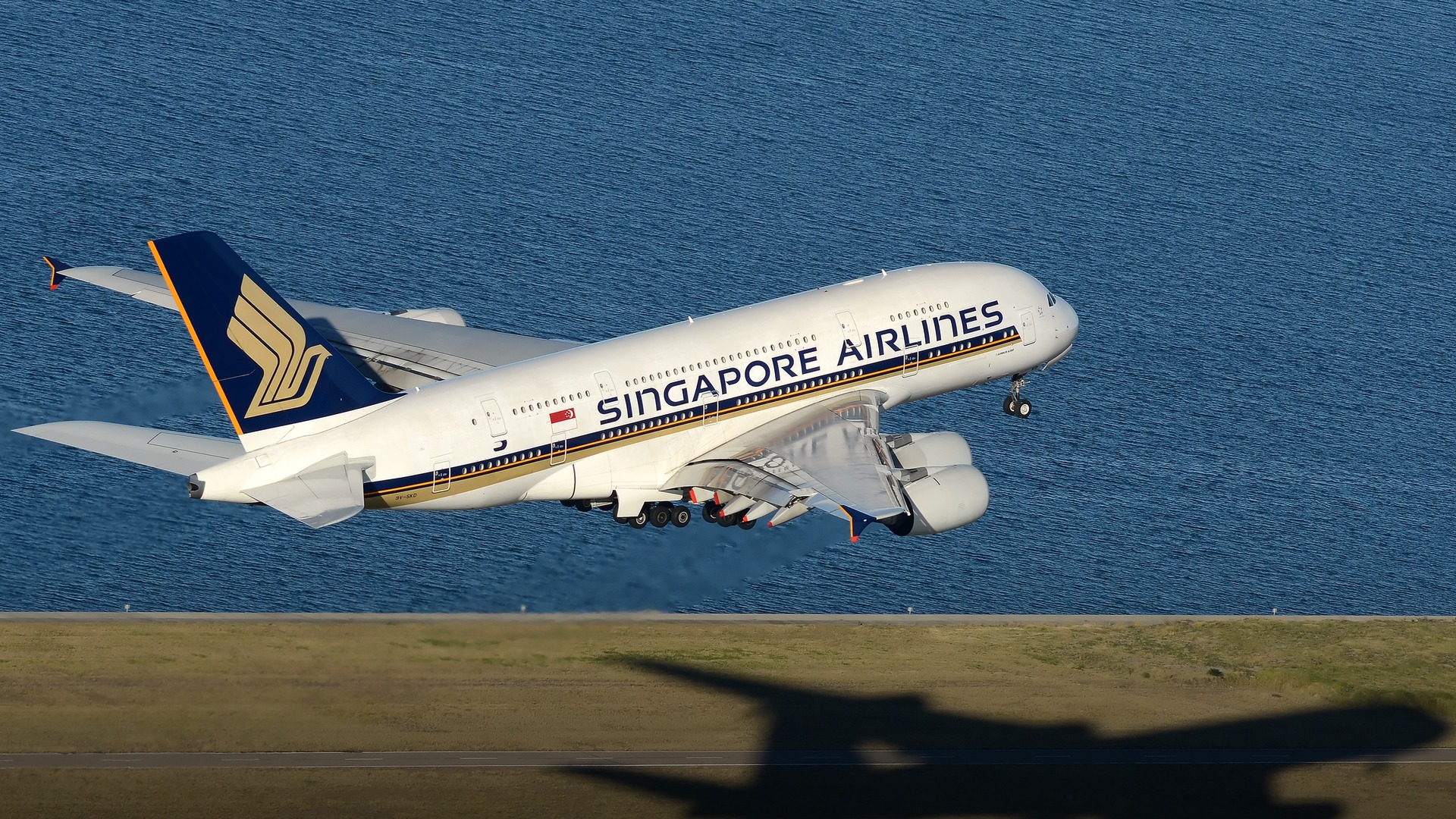 A massive Singapore Airlines Airbus A380 flagship superjumbo touching down smoothly at Sydney Airport.