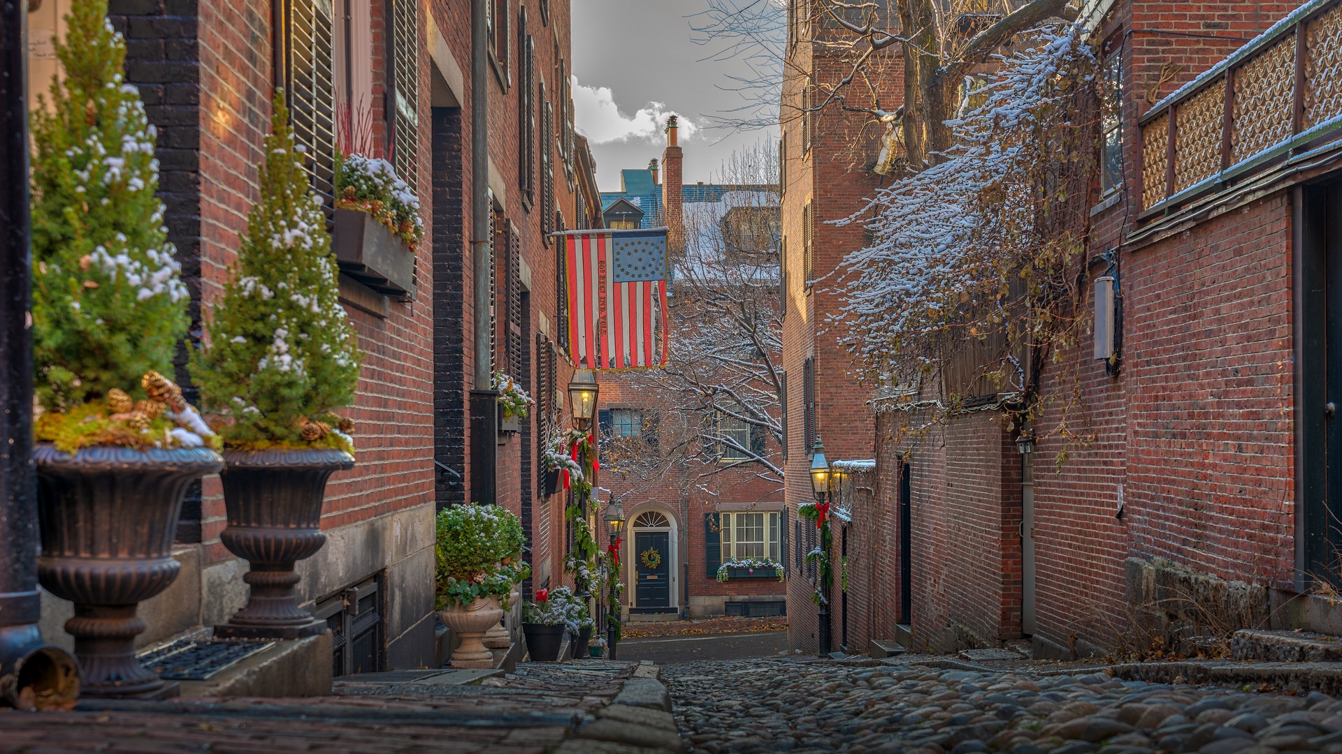 Historic brick townhouses along picturesque gaslit Acorn Street in the historic Beacon Hill neighborhood of Boston Massachusetts.