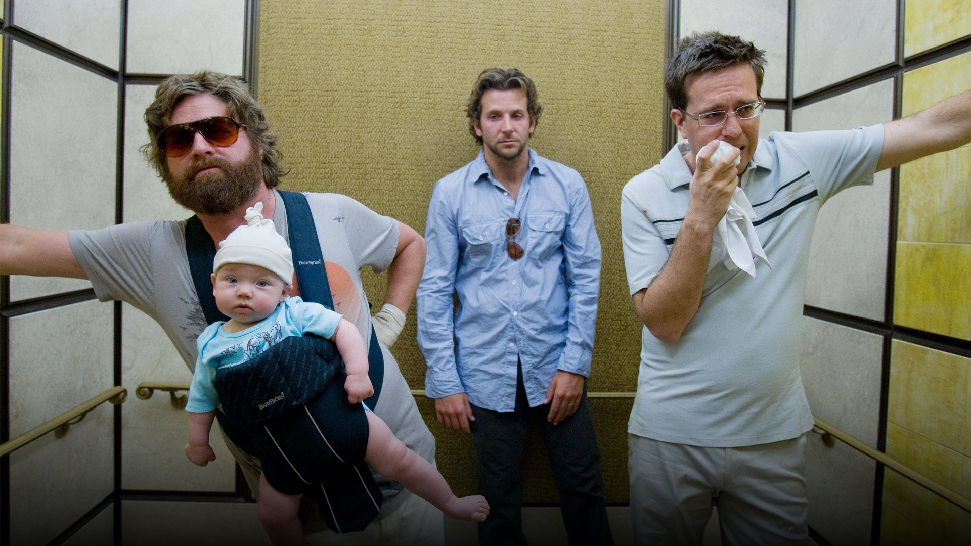 Bradley Cooper, Ed Helms, and Zach Galifianakis holding baby Carlos while walking through Caesar's Palace in The Hangover.