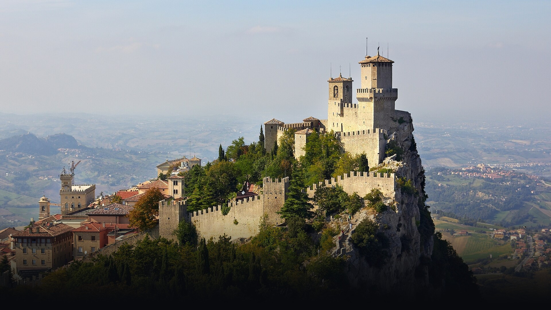 Historic stone fortress tower of Guaita crowning the cliff edge of Mount Titano in San Marino.