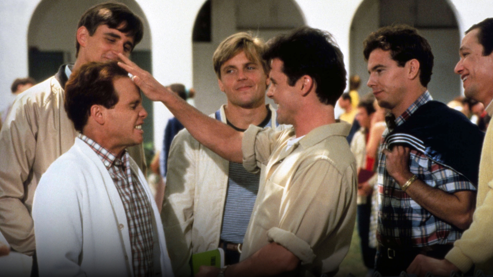 High school boys peering through a peep hole into the girls' locker room in the 1980s teen comedy Porky's.